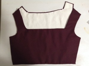 image shows inside of back bodice piece and outside of front bodice piece. Lining is white linen. Fashion fabric is burgundy wool.